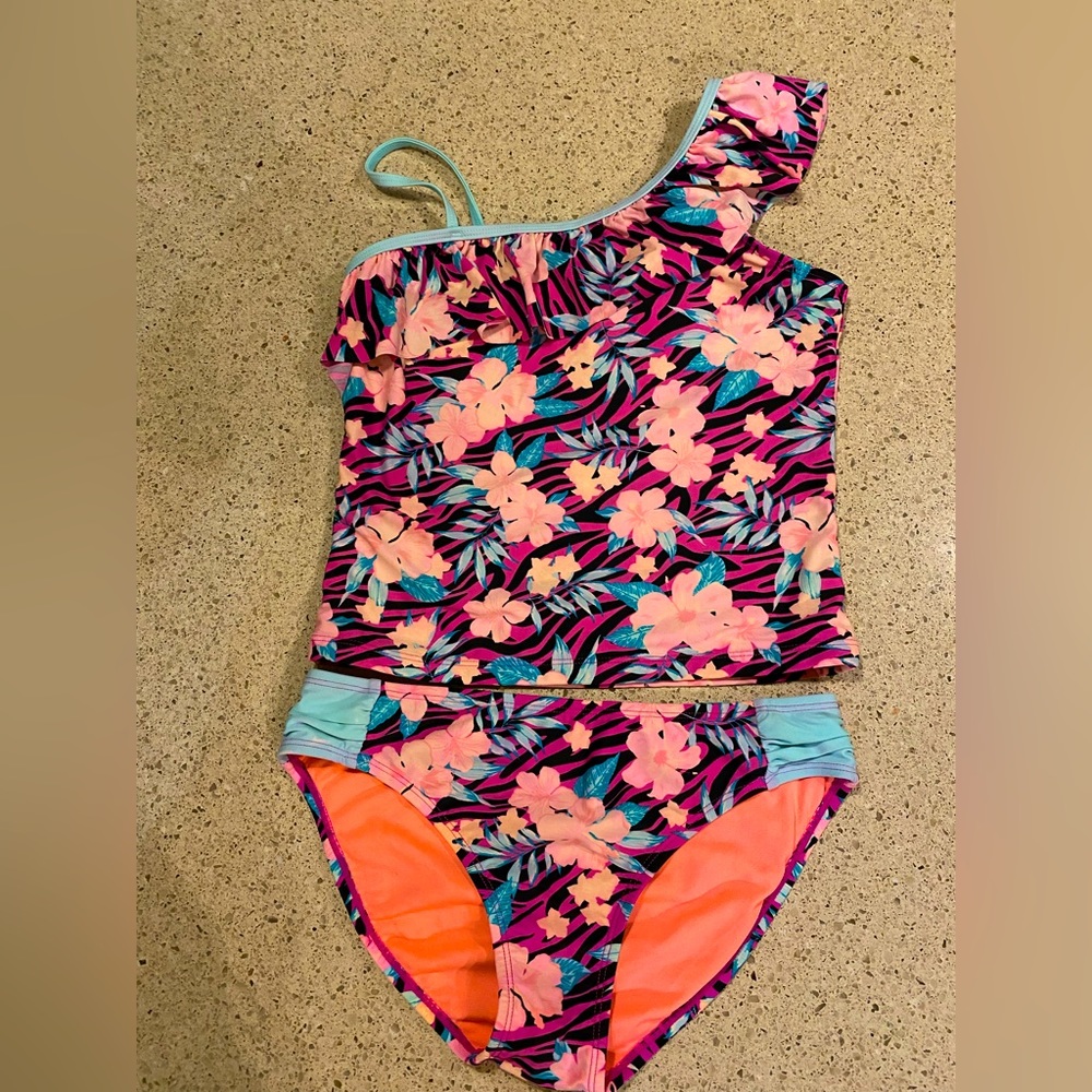 Swimsuit for girls. Tiger stripes and flowers on the swimsuit.